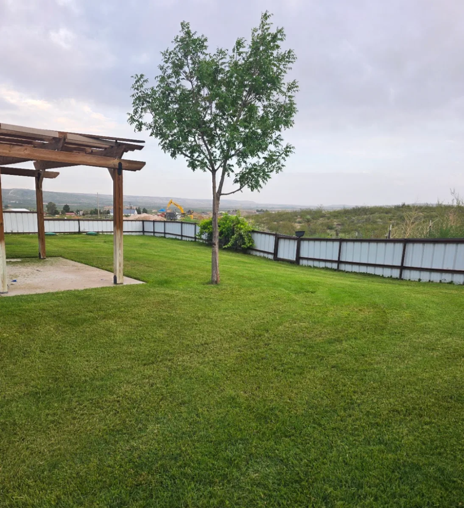 Landscaping in Eddy County - NM underway as a crew shapes planting beds beside a home